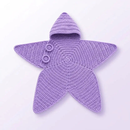 A lavender purple crocheted baby blanket shaped like a star, featuring a small hood with three buttons, laid flat on a light lavender background.